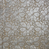 Silver laminated cotton guipure on an ecru background