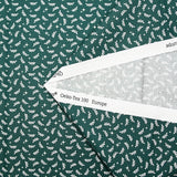 Popeline de coton imprimée rameaux et étoiles blanches fond vert