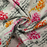 Cotton poplin printed with pink and orange foliage on a light gray background