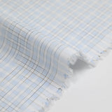 Polycotton poplin with brown checks and sky blue background