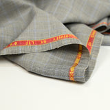 100% Prince of Wales wool suit fabric, black, blue, off-white background