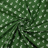 Cotton printed with white navy anchor, forest green background