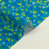 Cotton poplin printed yellow and blue bud with turquoise background