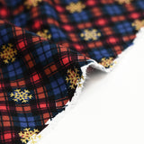 Cotton flannel printed with brown tartan and gold flakes