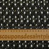 Puntilla de poliéster calada con entrelazado de lurex dorado, fondo negro