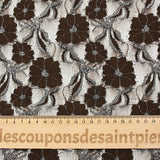 Martha metallic silver polyester lace with brown background