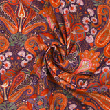 Cotton corduroy with orange paisley print and purple background