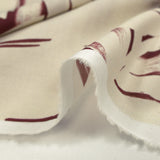Cotton voile printed with traces of leaves, burgundy background