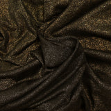 Fine iridescent gold jersey, black background