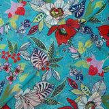 Mousseline imprimée fleurs exotiques rouge et blanc fond turquoise