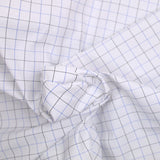 Dyed-woven polycotton poplin dotted black and blue with white background