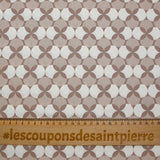 Coated poplin printed with white polka dots & clover on a glossy brown background