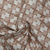 Coated poplin printed with white polka dots & clover on a glossy brown background
