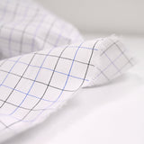 Dyed-woven polycotton poplin dotted black and blue with white background