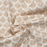Coated poplin with beige vegetable print on off-white background