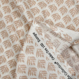 Coated poplin with beige vegetable print on off-white background
