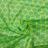 Coated poplin with turquoise vegetable print on lemon background