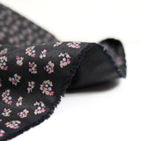 Polycotton poplin printed with flowers on black background