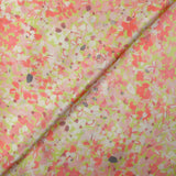 Silk satin printed with coral pink flowers on a pastel green background