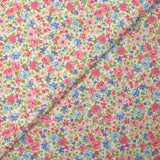 Cotton piqué printed with Sarah's flowers in blue and strawberry on a white background