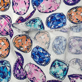 Viscose crepe with precious stone print on white background