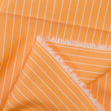 Striped dyed-woven cotton poplin with papaya background