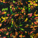 Viscose printed with squiggles of flowers on a black background