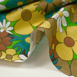 Algodón con estampado de flores disco turquesa, marrón y amarillo mantequilla