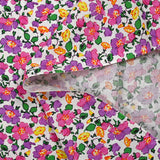 Cotton poplin printed mist of purple and pink flowers on white background
