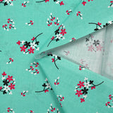 Cotton poplin printed with floral breath on aqua background