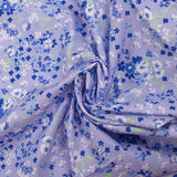 Cotton poplin printed with forget-me-not clouds, lavender background