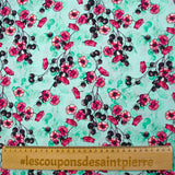Cotton poplin printed with floral clusters on a water green background