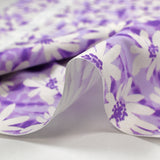 Cotton poplin printed with daisy vibration, purple background