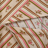 Cotton poplin printed diagonally with flowers on beige background