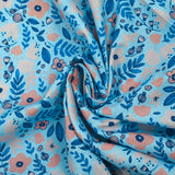 Cotton poplin printed with floral happiness on a sky blue background