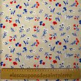 Cotton poplin printed with blue, white and red flowers on a greige background