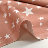 Cotton poplin printed with stars, old pink background