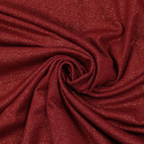 Jersey de poliéster iridiscente dorado con fondo rojo.
