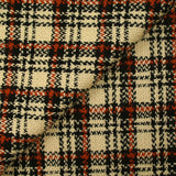 Burnt orange tartan wool tweed sand background