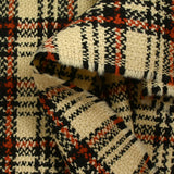 Burnt orange tartan wool tweed sand background