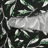 Satin viscose knit printed with a sprig of lily of the valley, black background