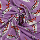 Satin viscose knit printed with a sprig of lily of the valley, mauve background