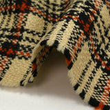 Burnt orange tartan wool tweed sand background