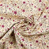 Cotton poplin printed with burgundy and beige flowers on an ecru background