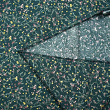 Popeline de coton imprimée brins de gui et étoiles dorées fond vert