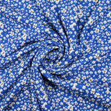 Viscose printed with white and yellow flowers, blue background