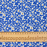 Viscose printed with white and yellow flowers, blue background
