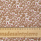 Viscose printed with white and burgundy flowers, hazelnut background