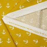Cotton printed with white navy anchor, ocher background