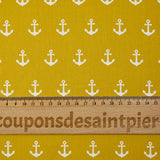 Cotton printed with white navy anchor, ocher background